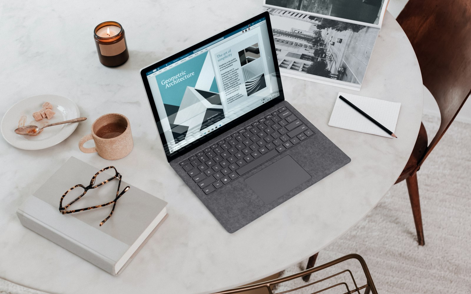 A laptop and coffee on a clean worktable